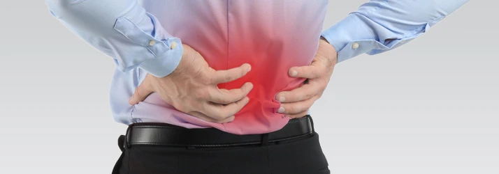 Man holding lower back in pain