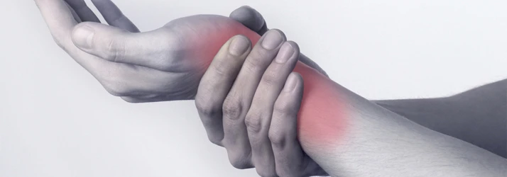 Patient with carpal tunnel holding wrist in pain