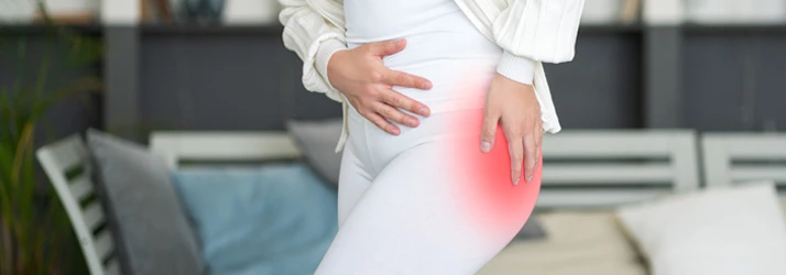 Woman holding her hip in pain