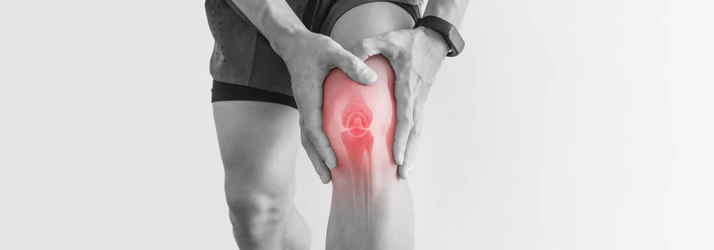 Man holding knee in pain