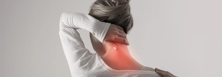Women holding neck in pain