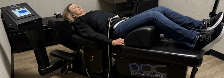 Patient laying on DOC spinal decompression table