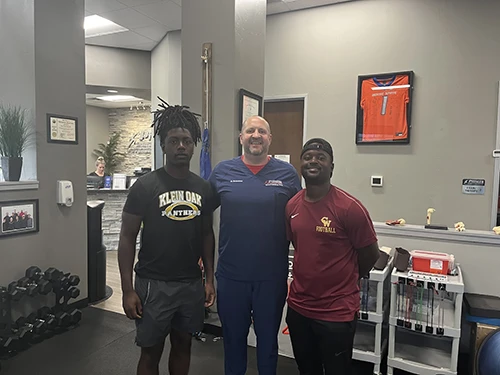 Athletes with their physical therapist